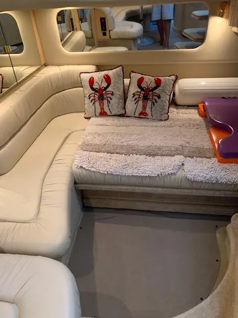 Slide: The Image of Interior of 2001 Sea Ray 380 Sundancer with plush seating and lobster-themed pillows. - 40