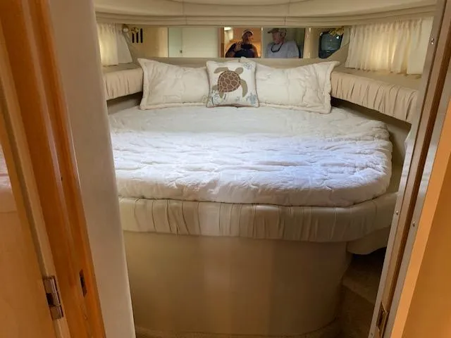 Slide: The Image of Cozy bedroom in 2001 Sea Ray 380 Sundancer yacht with plush bedding and decorative pillow. - 42