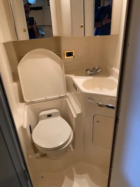 Slide: The Image of 2001 Sea Ray 380 Sundancer bathroom with toilet, sink, and mirror. - 45