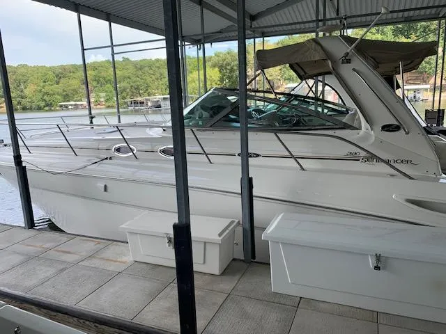 Slide: The Image of 2001 Sea Ray 380 Sundancer docked under a covered marina with scenic lake view. - 7