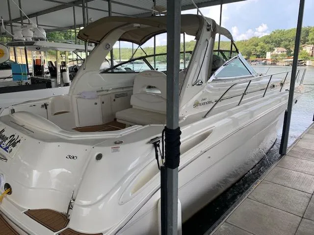 Slide: The Image of 2001 Sea Ray 380 Sundancer docked in a marina, showcasing sleek design and spacious deck. - 9