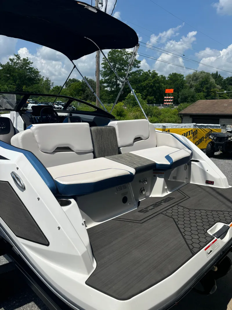 Slide: The Image of 2025 Scarab 195 H.O. boat with sleek seating and modern design under a sunny sky. - 2