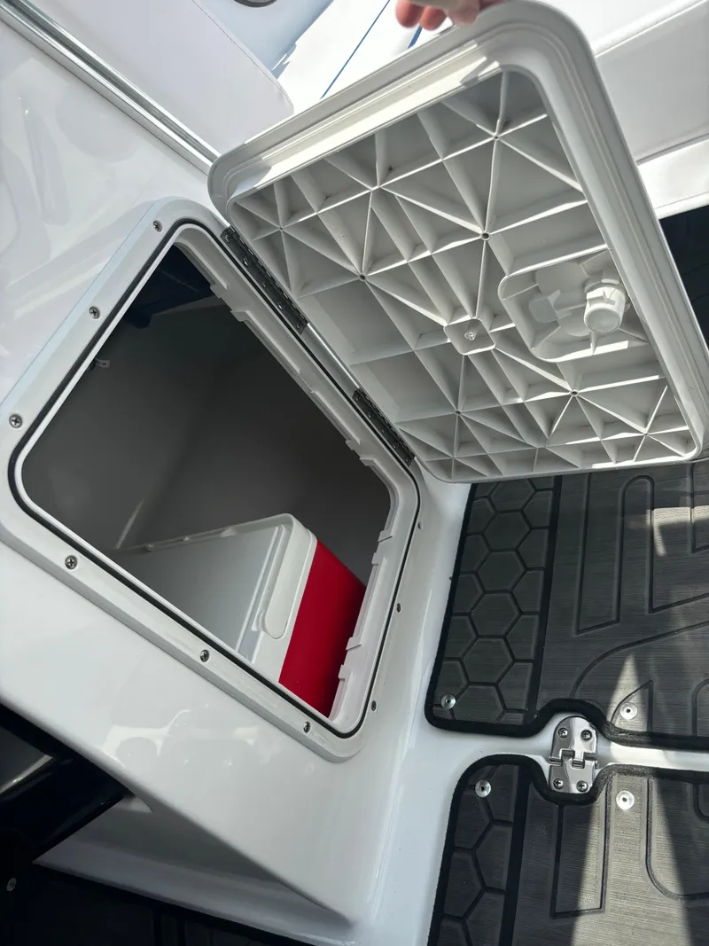 Slide: The Image of Storage compartment of 2025 Scarab 195 H.O. boat with open hatch and visible cooler. - 7
