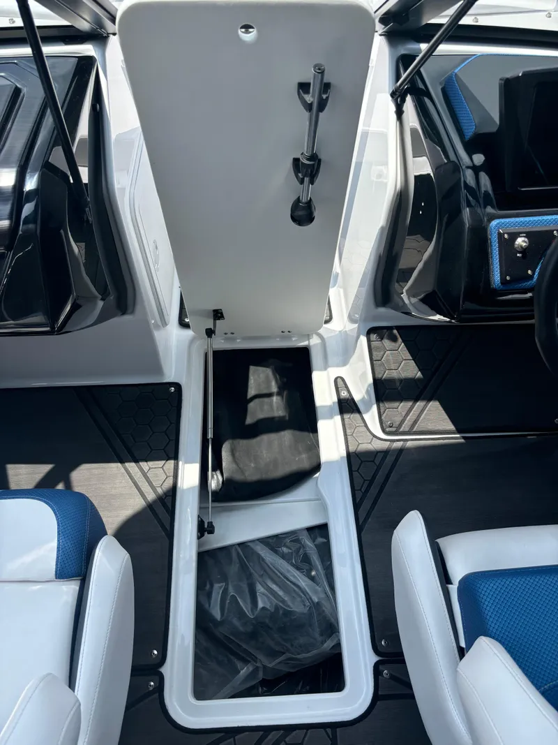 Slide: The Image of 2025 Scarab 195 H.O. boat interior storage compartment with open hatch and seating. - 8