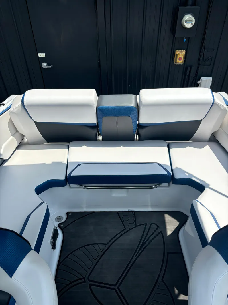 Slide: The Image of Interior seating of 2025 Scarab 195 H.O. boat with white and blue upholstery. - 9