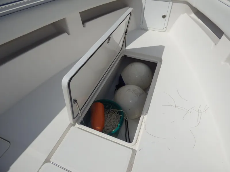 Slide: The Image of Storage compartment on 2011 Invincible 36 CC boat with buoys and rope. - 12