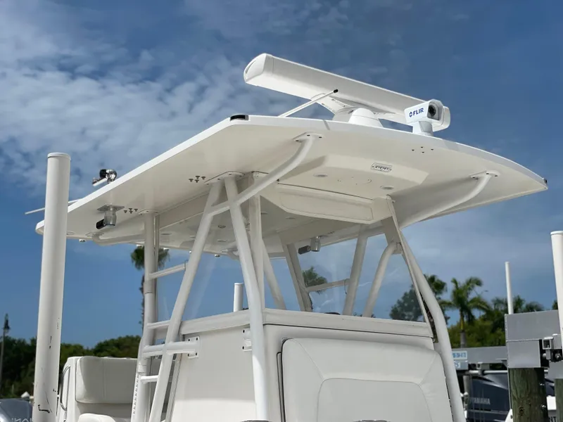 Slide: The Image of Invincible 36 CC 2011 boat with radar and T-top under clear sky. - 15