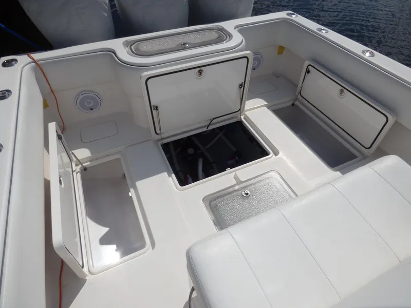 Slide: The Image of 2011 Invincible 36 CC boat deck with open storage compartments and seating. - 6