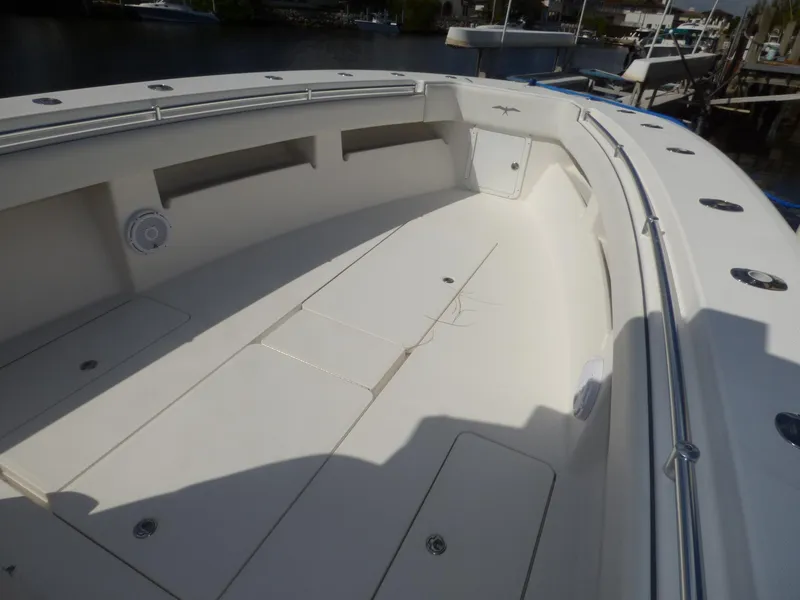 Slide: The Image of 2011 Invincible 36 CC boat deck with spacious seating and storage compartments. - 8