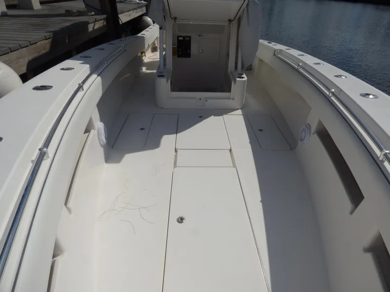 Slide: The Image of 2011 Invincible 36 CC boat interior with open deck and storage compartments. - 9