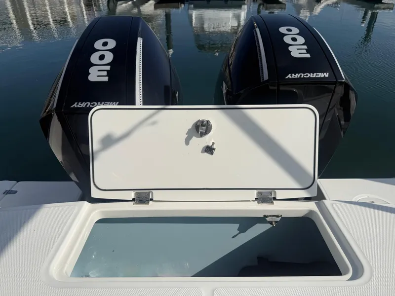 Slide: The Image of Boston Whaler 330 Outrage 2021 with dual Mercury 300 engines and open storage compartment. - 10