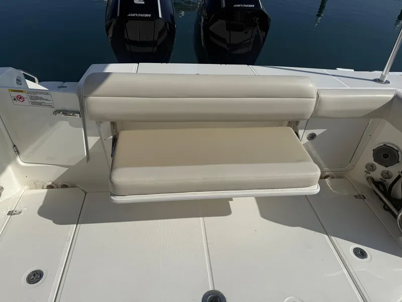 Slide: The Image of 2021 Boston Whaler 330 Outrage boat with foldable bench seat and twin Mercury engines. - 12
