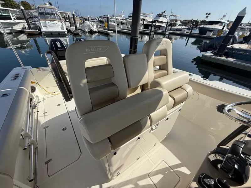 Slide: The Image of 2021 Boston Whaler 330 Outrage boat interior with dual seats at marina. - 17