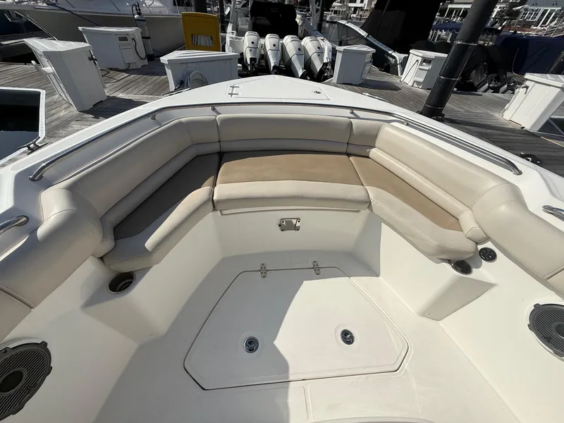 Slide: The Image of 2021 Boston Whaler 330 Outrage boat interior with cushioned seating and deck view. - 24