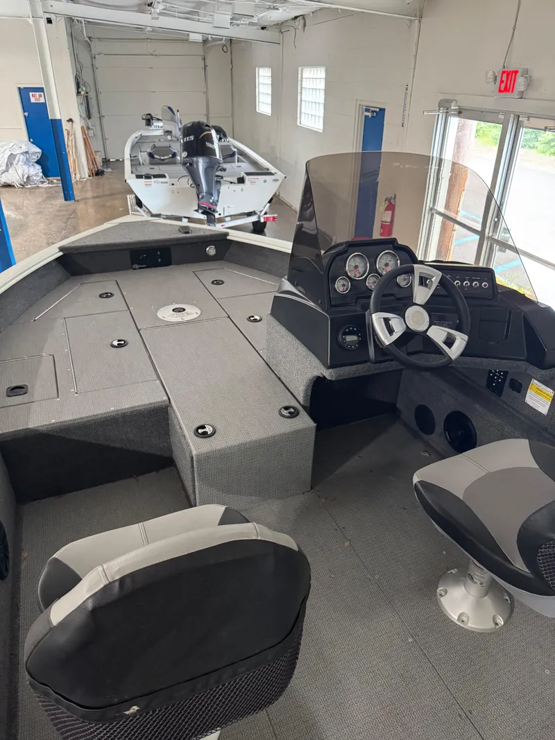 Slide: The Image of 2024 G3 AV17C Vinyl boat interior with steering console and seating in a showroom. - 10