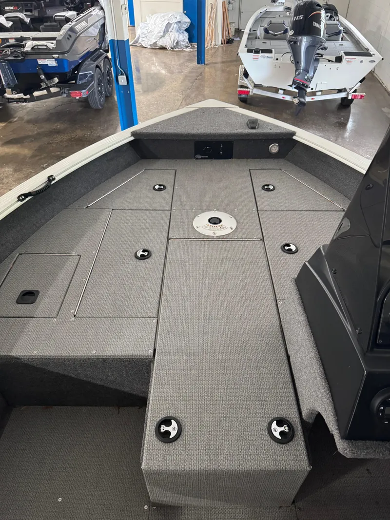 Slide: The Image of 2024 G3 AV17C Vinyl boat interior with gray deck and storage compartments. - 13