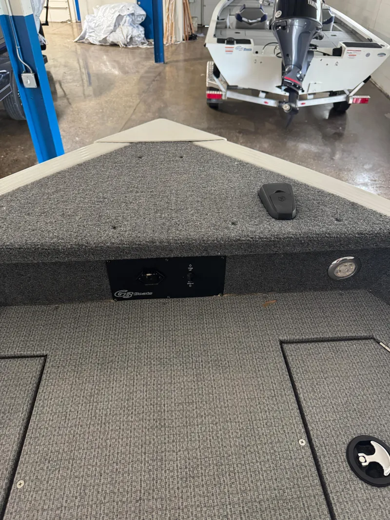 Slide: The Image of 2024 G3 AV17C Vinyl boat interior with gray carpet and control panel. - 18