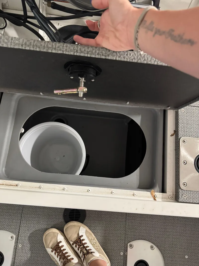 Slide: The Image of Open storage compartment on G3 AV17C Vinyl boat, showing interior and white bucket. - 5