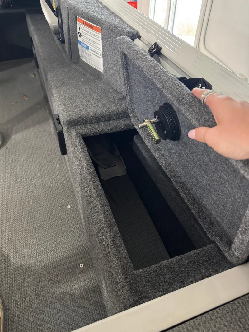 Slide: The Image of 2024 G3 AV17C Vinyl boat storage compartment with open lid, showing interior space. - 7