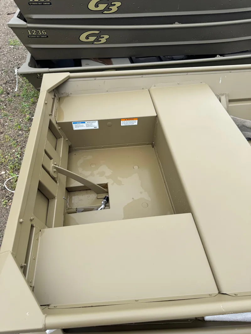 Slide: The Image of 2025 G3 1436LW boat interior, showcasing storage and seating area. - 2