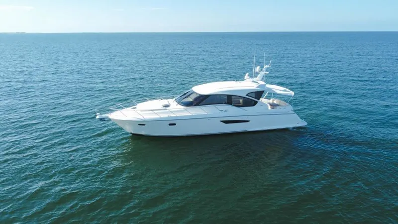 Slide: The Image of 2008 Tiara Yachts 5800 Sovran cruising on open water. - 24