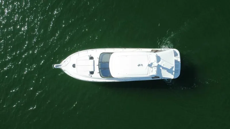 Slide: The Image of Aerial view of 2008 Tiara Yachts 5800 Sovran cruising on green water. - 26