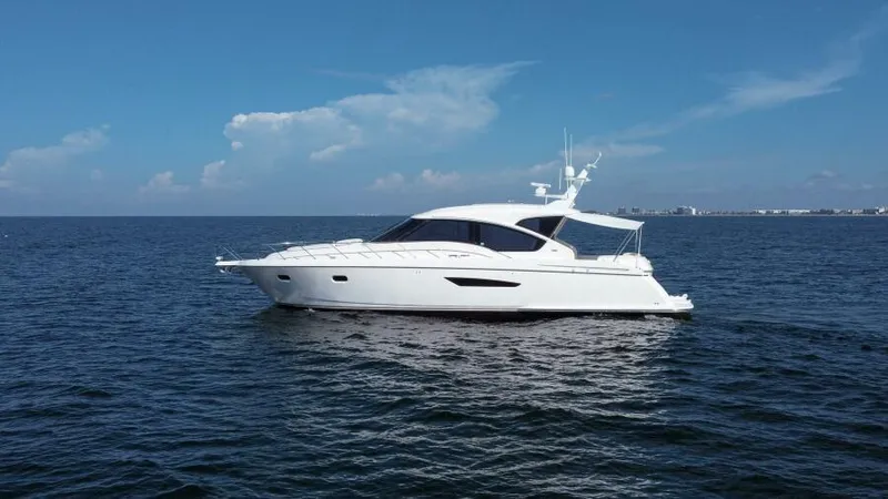 Slide: The Image of 2008 Tiara Yachts 5800 Sovran cruising on open water under clear skies. - 29