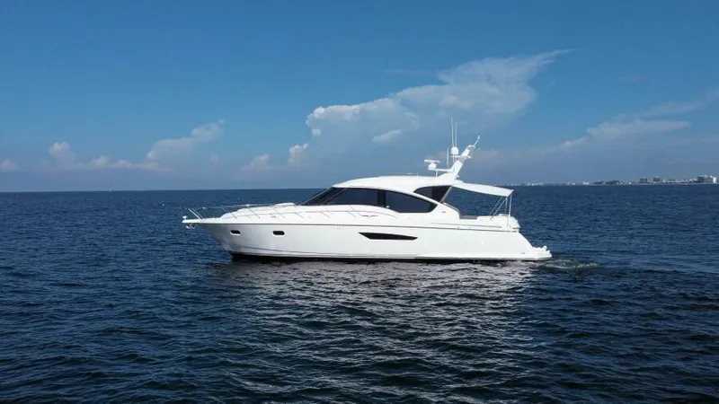 Slide: The Image of 2008 Tiara Yachts 5800 Sovran cruising on open water under clear skies. - 31