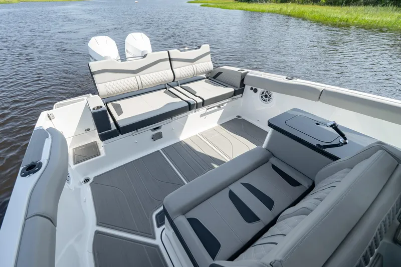 Slide: The Image of 2026 Monterey Elite 30 OB boat interior with spacious seating and modern design on the water. - 10
