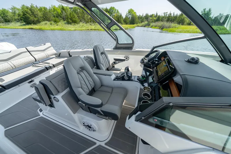 Slide: The Image of Luxurious 2026 Monterey Elite 30 OB boat interior with plush seating and modern dashboard. - 13