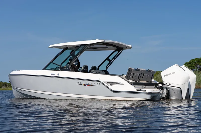 Slide: The Image of 2026 Monterey Elite 30 OB boat on water, featuring sleek design and Mercury outboard engine. - 5