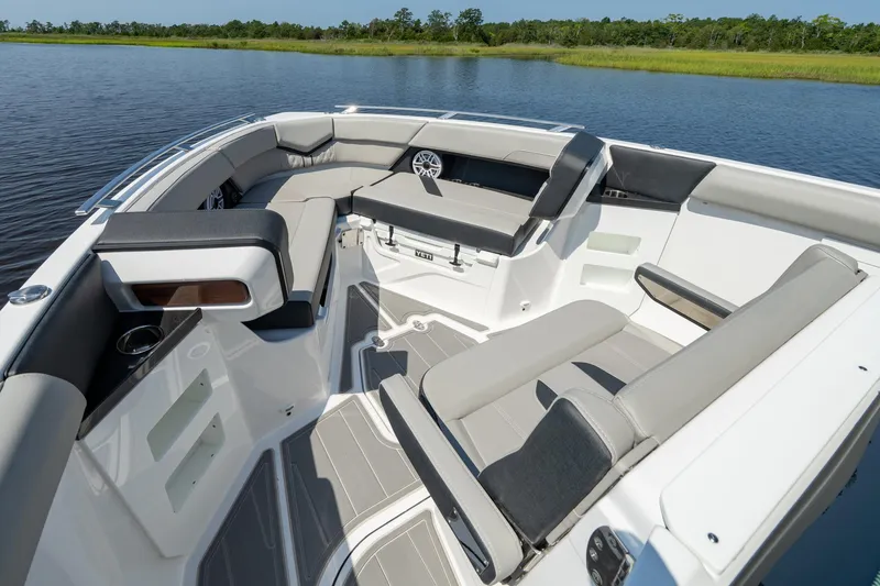 Slide: The Image of Luxurious seating area on the 2026 Monterey Elite 30 OB boat, surrounded by serene water. - 6