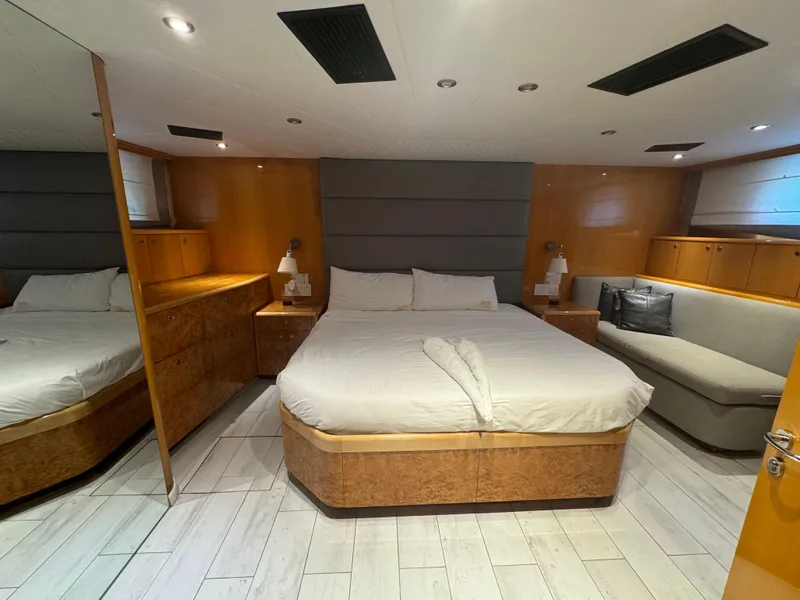 Slide: The Image of Luxurious bedroom interior on 2000 Baglietto 116 yacht with modern furnishings and cozy lighting. - 11