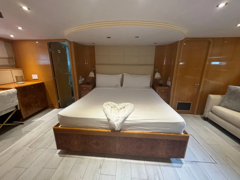 Slide: The Image of Luxurious bedroom interior on 2000 Baglietto 116 yacht with elegant wood finishes. - 15