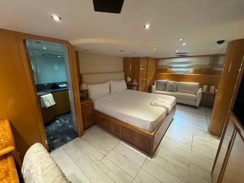 Slide: The Image of Luxurious bedroom interior of 2000 Baglietto 116 yacht with modern furnishings and en-suite bathroom. - 16