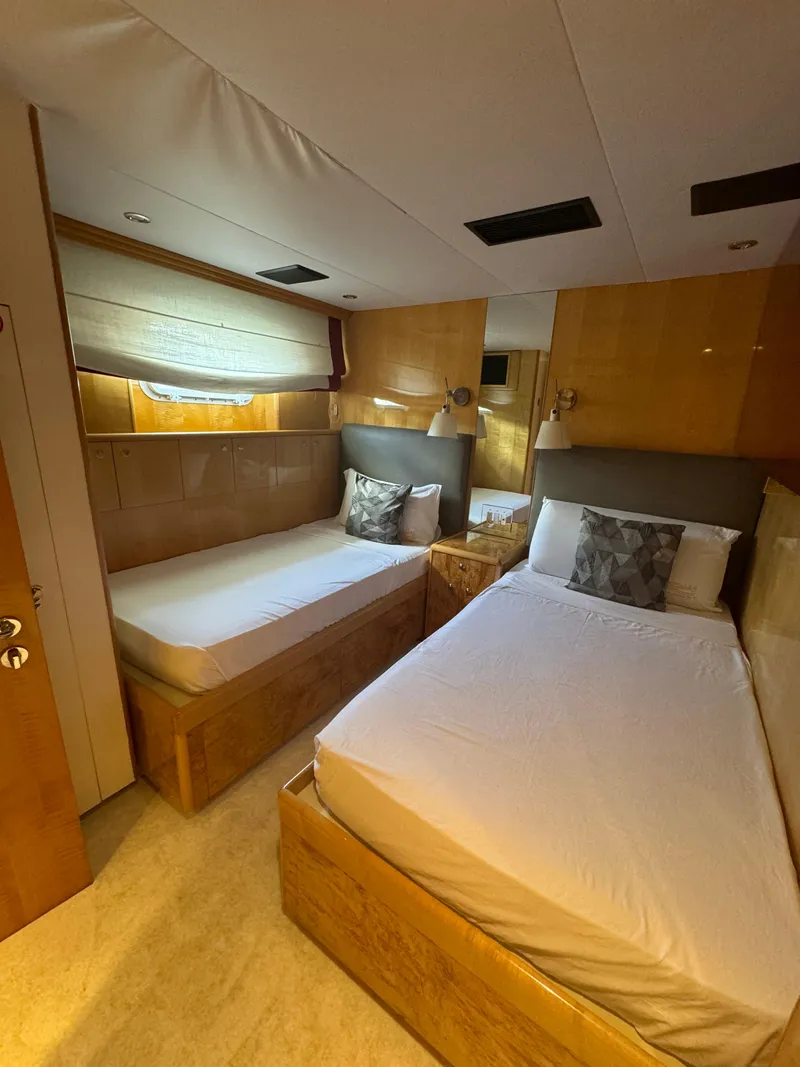 Slide: The Image of Luxurious twin bedroom on 2000 Baglietto 116 yacht with modern wood finishes. - 20