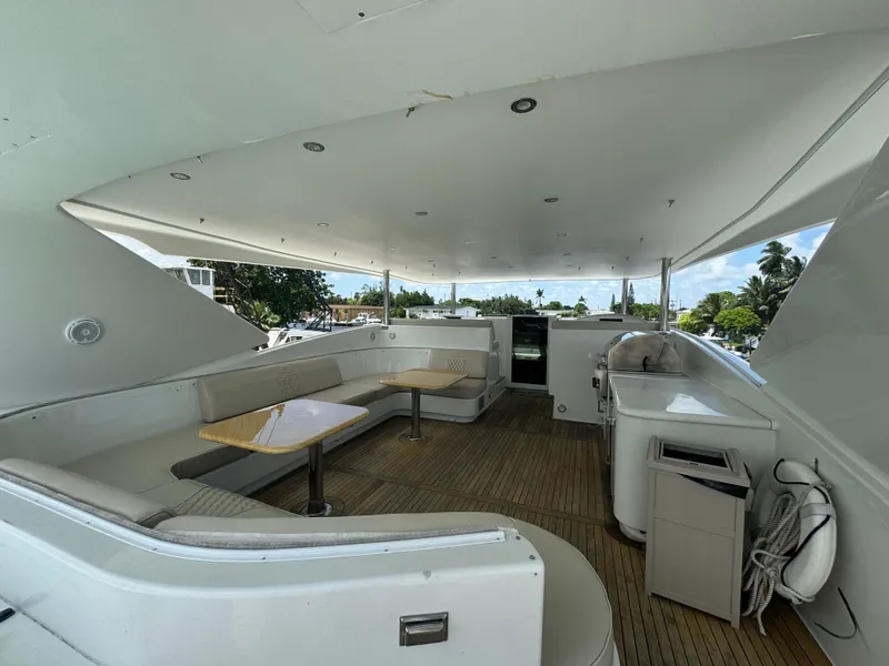 Slide: The Image of Spacious deck of 2000 Baglietto 116 yacht with seating and tables. - 21