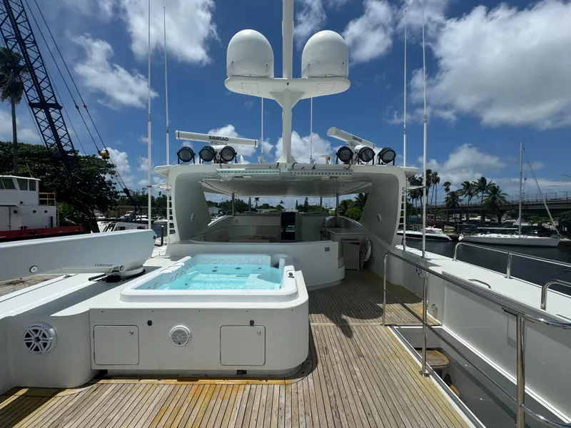 Slide: The Image of Luxurious 2000 Baglietto 116 yacht deck with hot tub and clear blue sky. - 24