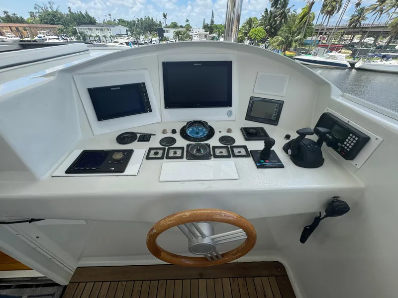 Slide: The Image of Helm of 2000 Baglietto 116 yacht with navigation instruments and wooden steering wheel. - 25