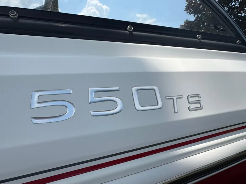 Slide: The Image of Close-up of 2020 Tahoe 550TS boat model emblem on white surface. - 10
