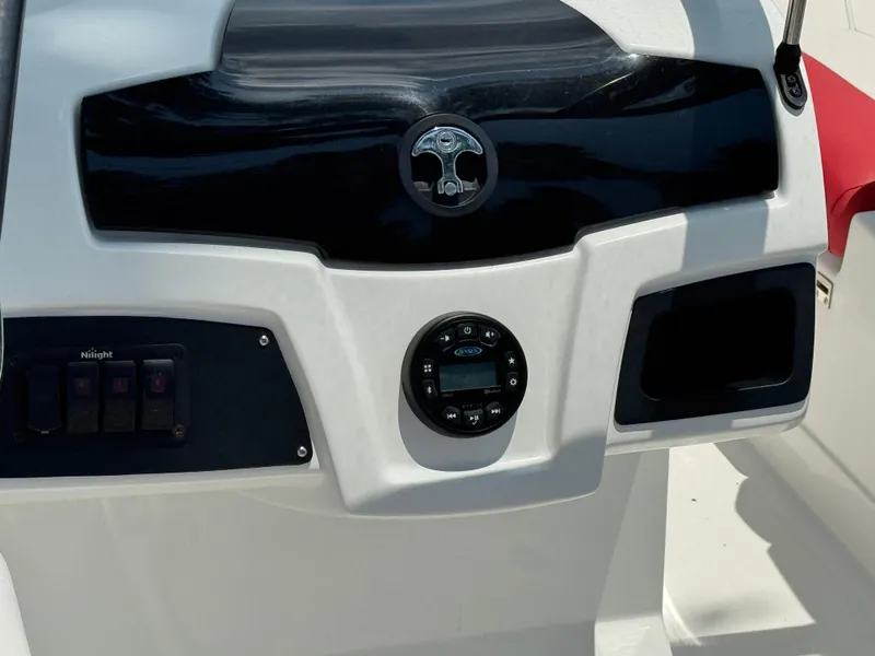 Slide: The Image of Control panel of a 2020 Tahoe 550TS boat with audio system and switches. - 12