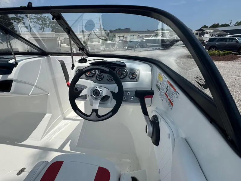 Slide: The Image of Interior view of a 2020 Tahoe 550TS boat cockpit with steering wheel and dashboard. - 13