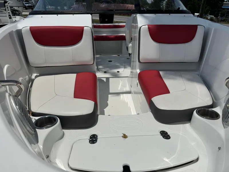 Slide: The Image of 2020 Tahoe 550TS boat interior with red and white seating, cup holders, and sleek design. - 3