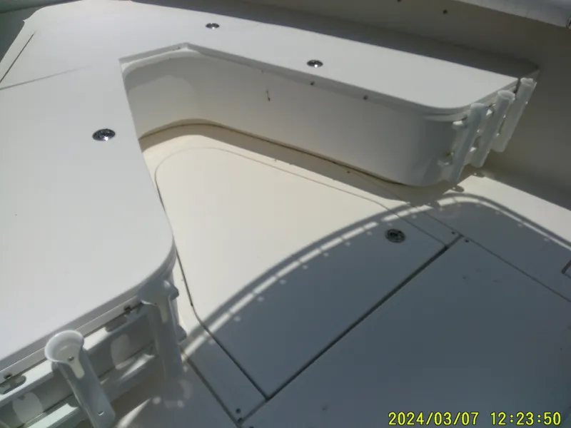 Slide: The Image of 2006 McKee Craft FREEDOM TE 28 boat deck with rod holders and storage compartments. - 17