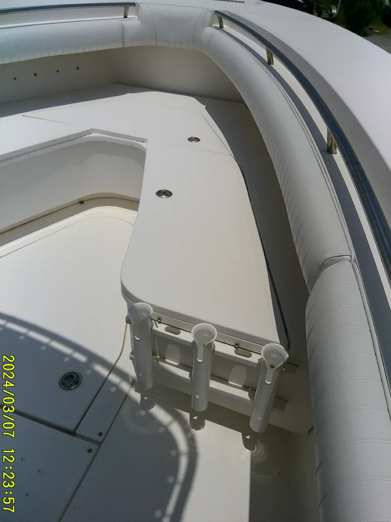Slide: The Image of 2006 McKee Craft FREEDOM TE 28 boat interior with rod holders and cushioned seating. - 18