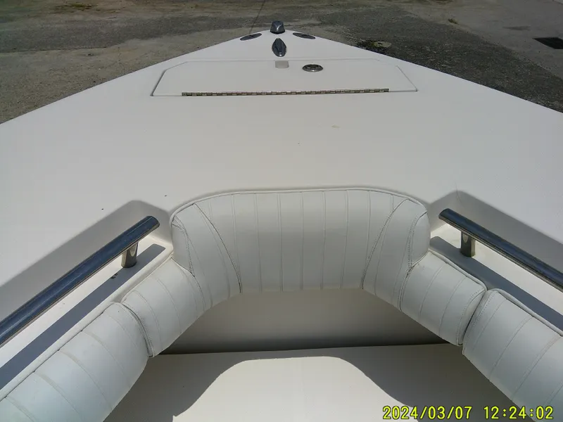 Slide: The Image of 2006 McKee Craft FREEDOM TE 28 boat interior with white cushioned seating. - 19