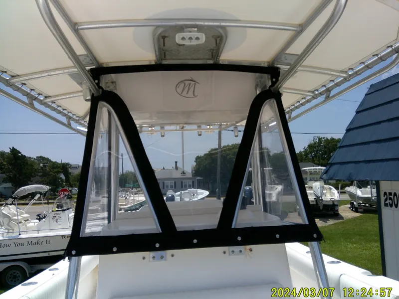 Slide: The Image of 2006 McKee Craft FREEDOM TE 28 boat interior with T-top and clear panels. - 26
