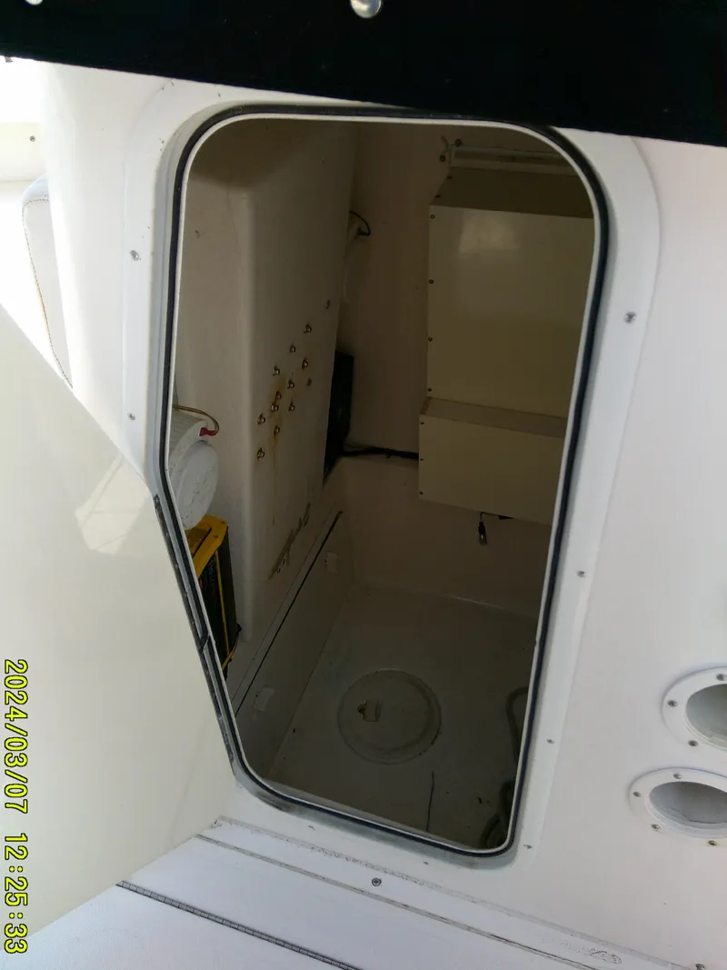 Slide: The Image of 2006 McKee Craft FREEDOM TE 28 boat interior, showing open hatch and storage area. - 31