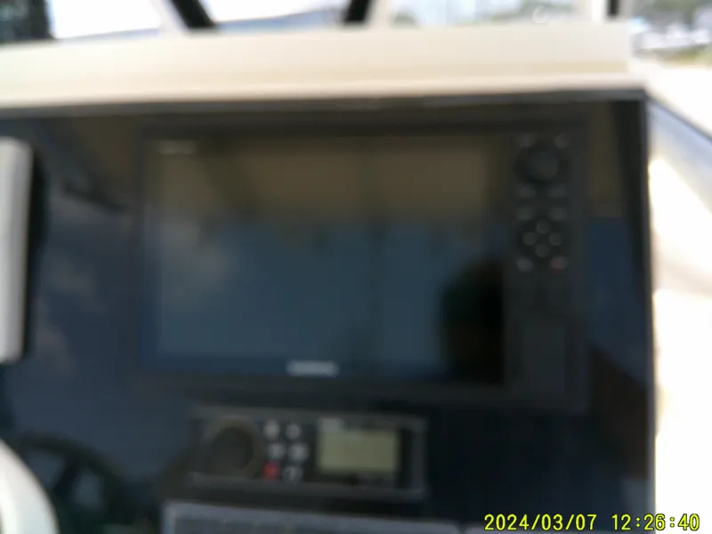 Slide: The Image of Blurred dashboard of a 2006 McKee Craft FREEDOM TE 28 boat with electronic display. - 42