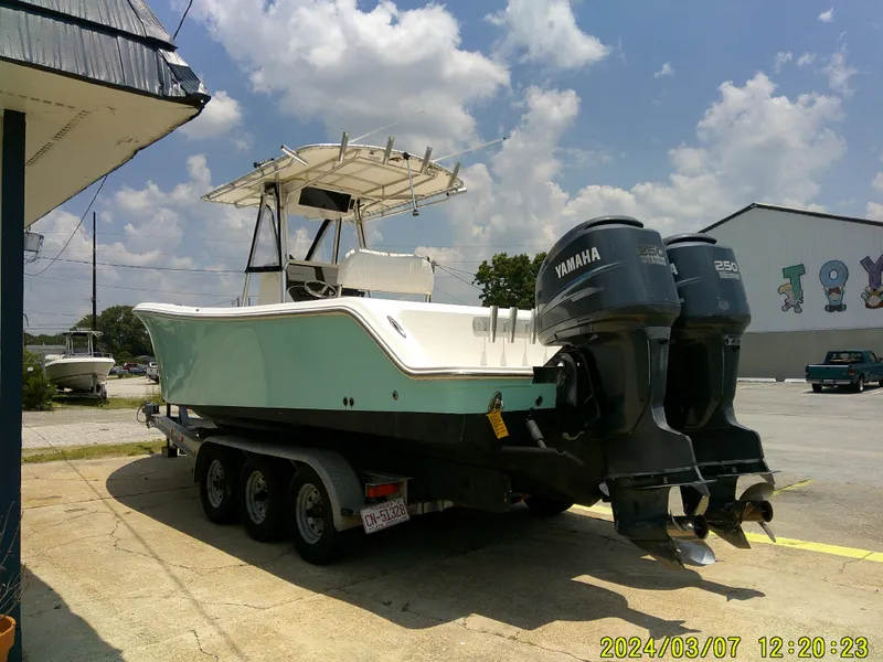 Slide: The Image of 2006 McKee Craft FREEDOM TE 28 boat with twin Yamaha engines on a trailer. - 7